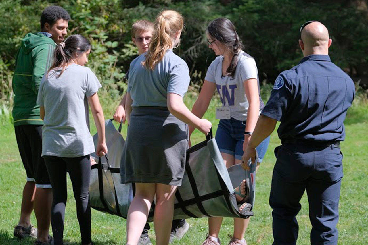 Marysville firefighter Dustin Jensen watches students carry a victim. (Courtesy photos)