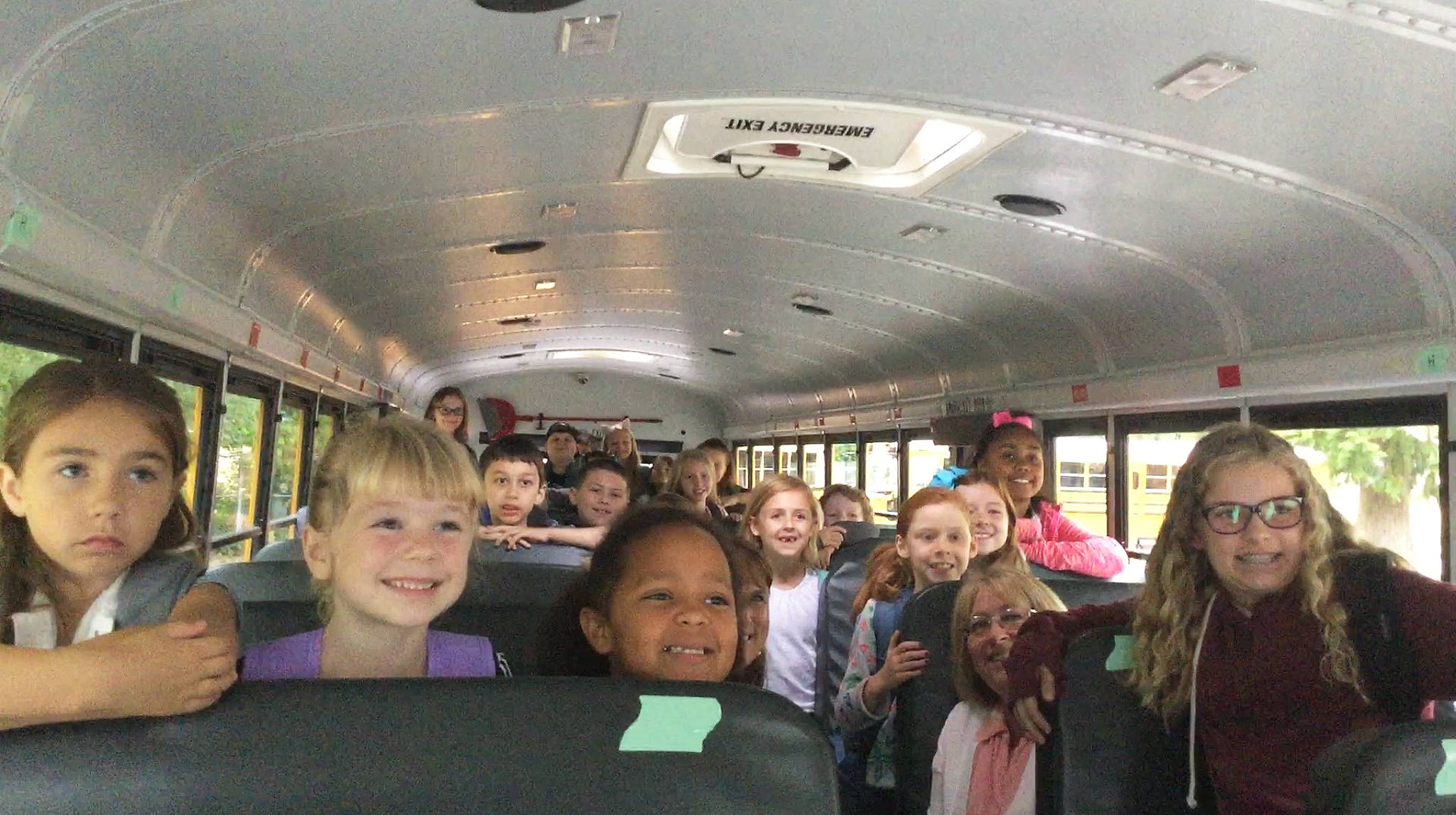 DOUGLAS BUell/Staff Photos                                 Students on their first day back to Eagle Creek Elementary School were joined Wednesday by a couple of distinguished bus riders, Arlington Mayor Barb Tolbert and School District Superintendent Chrys Sweeting, in the second row; below left, welcome back hug for a student; mayor and superintendent chat with kids about what they did over the summer.