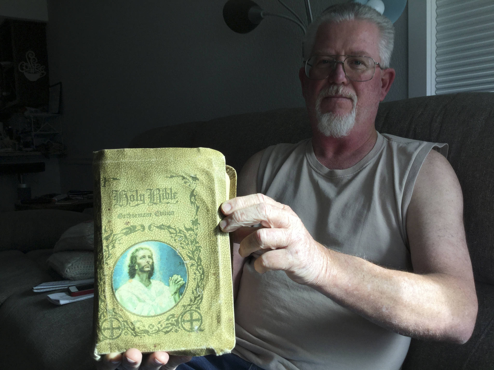 Bill Gardner of Arlington holds up a family Bible missing for half a century and found by an Eastern Washington author in a second-hand bookstore.
