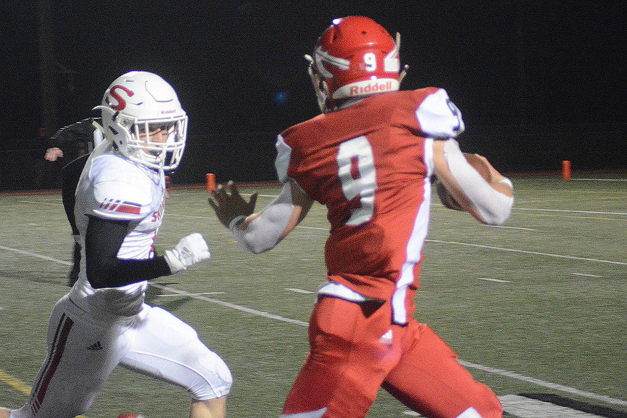 Jordan Justice runs for a score in a recent game. Justice had an interception and two TDs in the loss to Lincoln. (Steve Powell/File Photo)