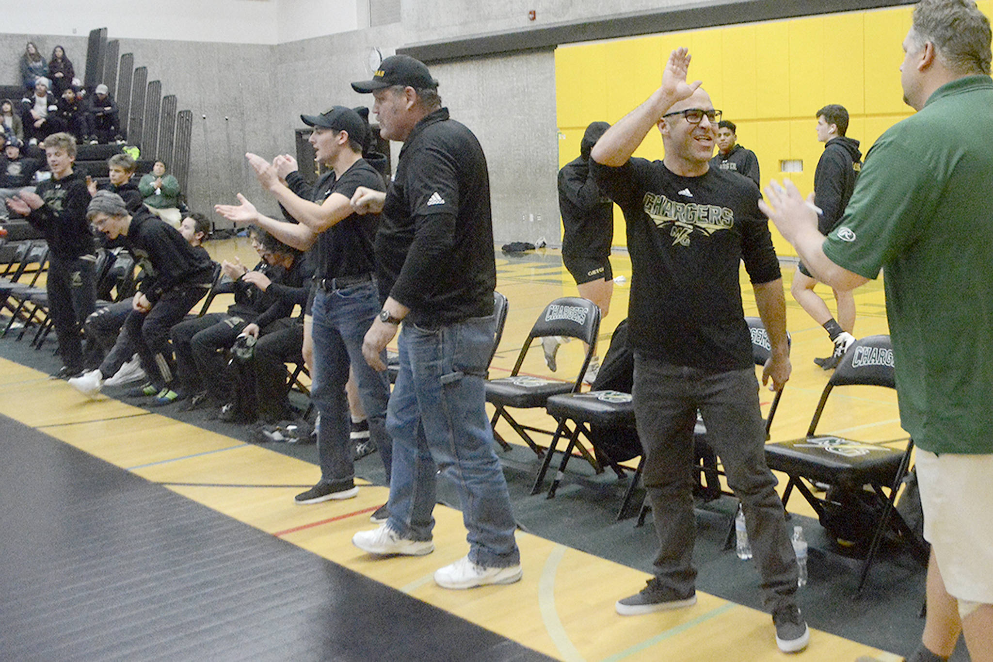 MG coach John Deaver has enough high 5’s to go all around after the Chargers beat M-P for the first time ever in wrestling. (Steve Powell/Staff Photos)