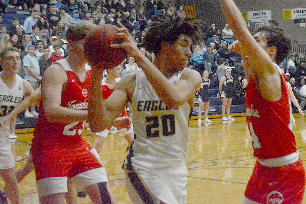 Will Abram (20) of Arlington grabs a rebound against M-P Wednesday night. (Steve Powell/Staff Photo)