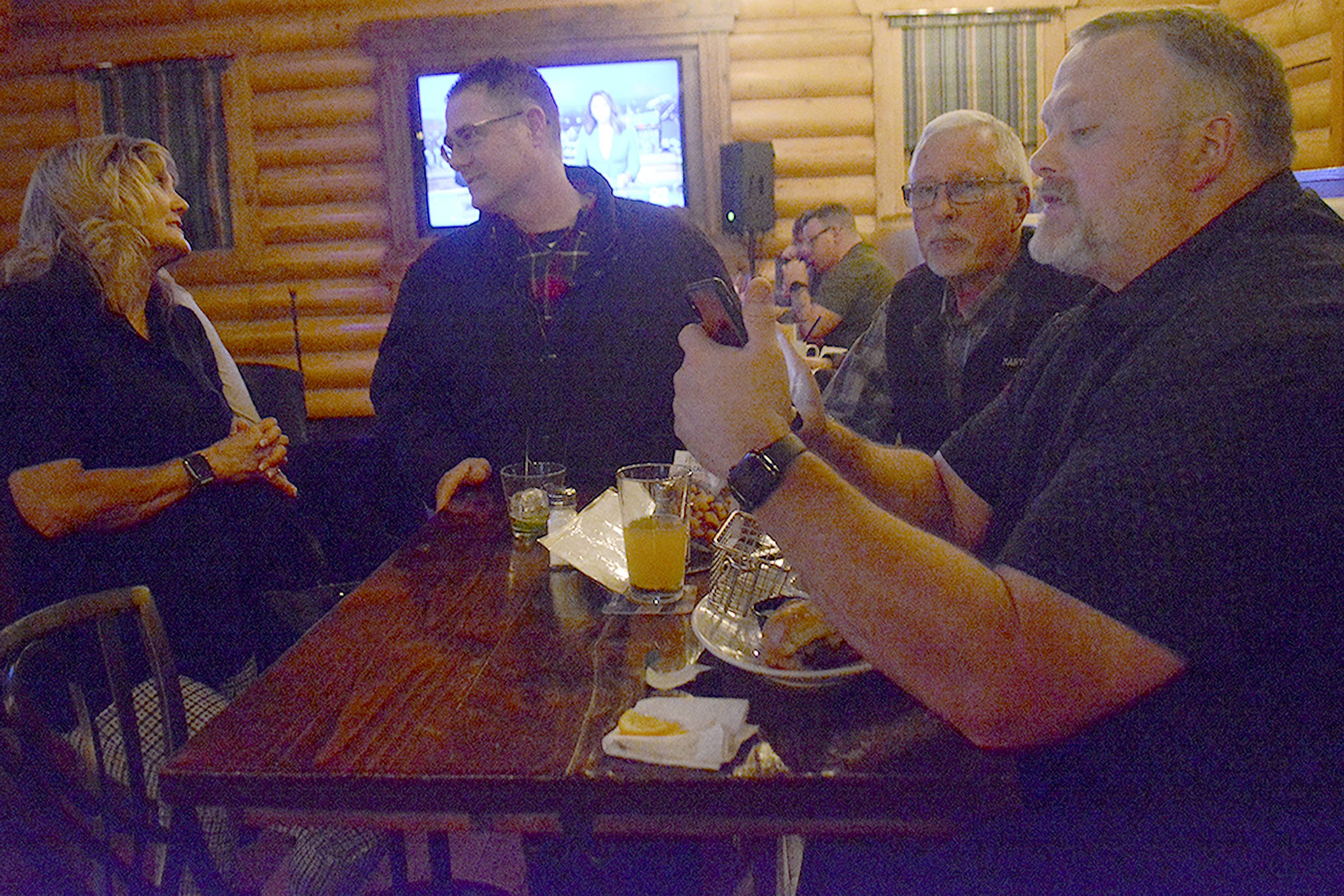 Scott Beebe, an assistant superintendent with the Marysville School District, looks at election results on his phone Tuesday night. (Steve Powell/Staff Photo)