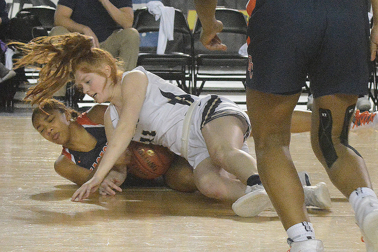 Makenzie Gage played a tough game inside against the taller Crusaders, here falling to the floor.