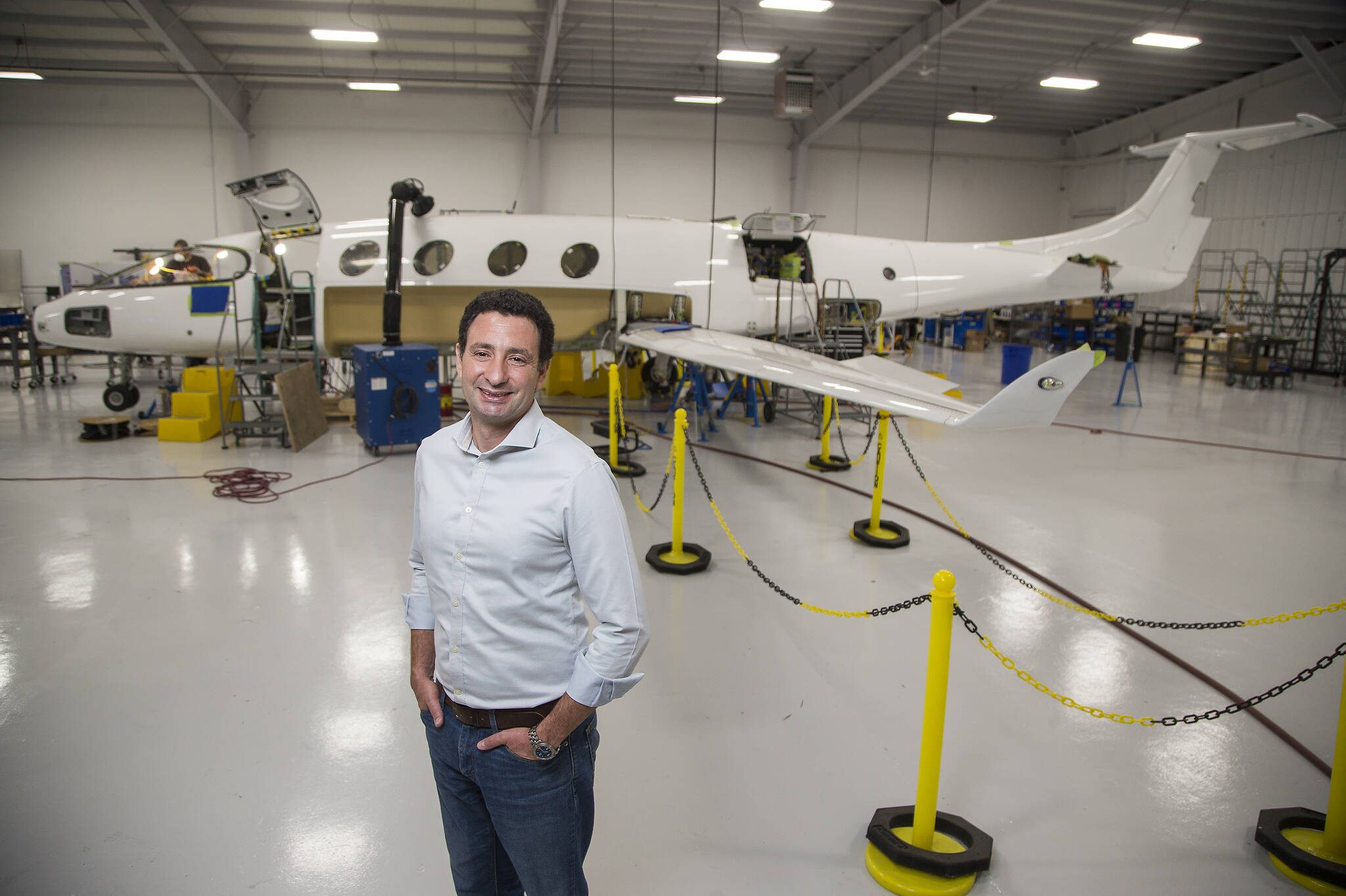 Eviation co-founder and former CEO Omer Bar-Yohay stands by the company’s all-electric airplane, Alice, at Eviation’s plant in Arlington in September. (Andy Bronson / Herald file)