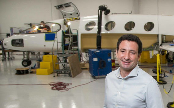 Eviation Co-founder and CEO Omer Bar-Yohay stands by the first all electric plane, the Alice, at Eviation's plant on Wednesday, Sept. 8, 2021 in Arlington, Washington.  (Andy Bronson / The Herald)