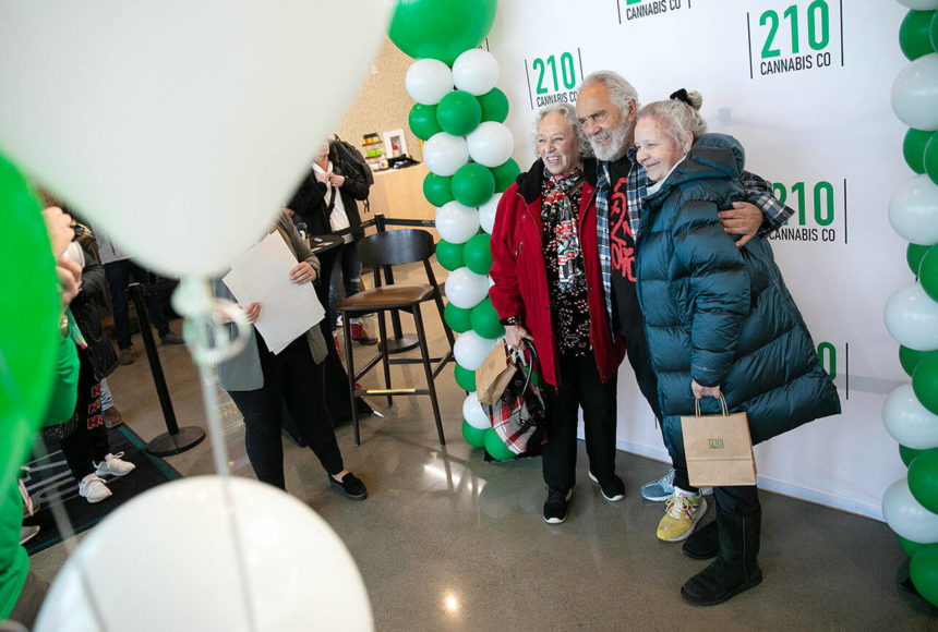 <p>Carla Fisher and Lana Lasley take a photo together with Tommy Chong during 210 Cannabis Co’s grand opening Saturday, Dec. 10, 2022, in Arlington, Washington. Fisher and Lasley waited in line solely to get a photo with Chong. (Ryan Berry / The Herald)</p>